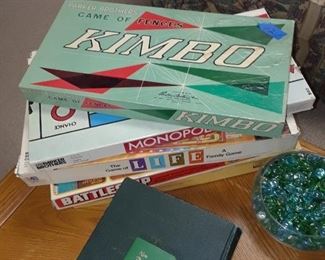 All kinds of vintage board games including several sets of vintage bakelite dominos in green, red, and butterscotch