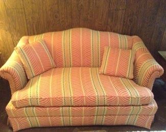 Coral and beige love seat.