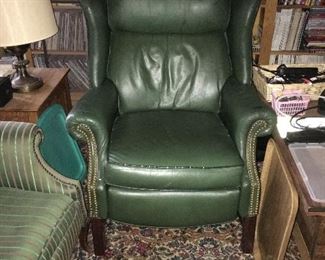 One of a pair of green leather recliners