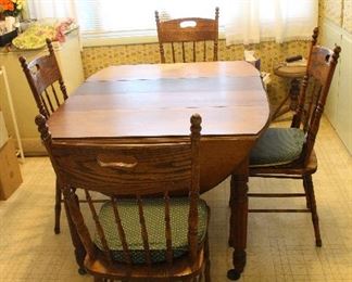 Wooden Kitchen table with drop leaf ends and two leaves.