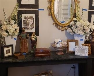 Marble top table, framed prints, carved and painted saint, ceramic St. Francis, shells, frames, wood box. Silk florals