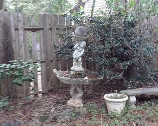 Fountain featuring dolphin base and cherub