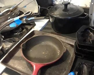 Le Cruset skillet, Cuisinart pot, cast iron skillet and cornbread pan