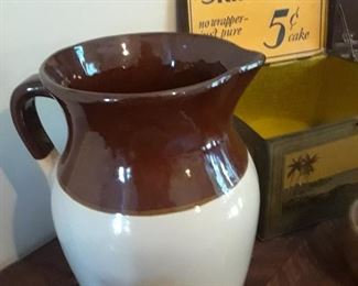 Close-up of pitcher and  tin box advertising soaps