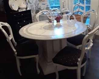 Painted dining table on pedestal base and four chairs