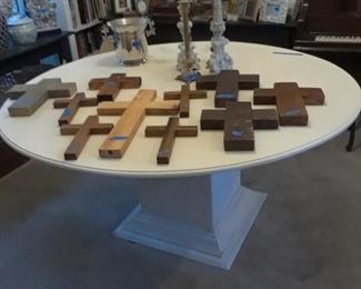 Another dining table with pedestal base. Large selection of crosses, candlesticks, and other decorative accessories.