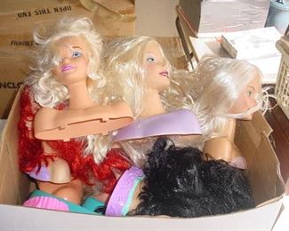 Many Barbie heads, plus Barbie and Ken dolls, and clothing