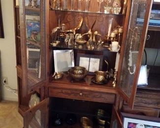 Lenoir House glass door display cabinet section, lighted upper cabinet & lighted lower cabinet, & storage drawer shown with doors open, most brass-SOLD, cut glass decanter, oval brass tureen