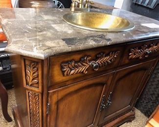 Vanity with brass sink and granite top