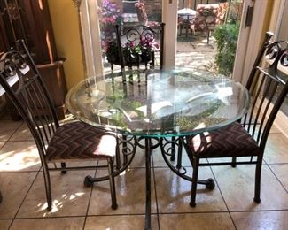 Round Glass Top Table with Scrolled Iron Legs, Including 4 Iron Chairs with Upholstered Seats