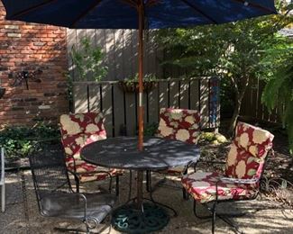 Outdoor Iron Patio Table and 4 Rocker Style Chairs. Umbrella Included   