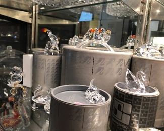 Swarovski Figurines with original boxes.  Swan, dog, golfer, squirrel, duck, bear, birds, toucan, parrots, pyramid & more