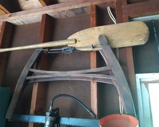 Antique saw and vintage paddle