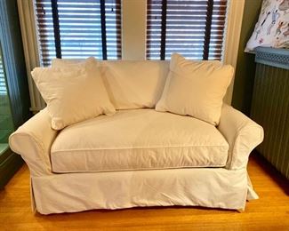 Slip-covered twin sleeper loveseat