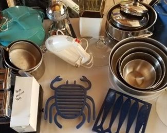 Mixing bowls, Farberware pots, Dansk Kobestyle pot with trivet lid, pasta machine, stock pot, stainless steel mixing bowls with lids, cat iron trivets, hand mixer, popcorn machine, standing manual juicer, glass dome/cloche