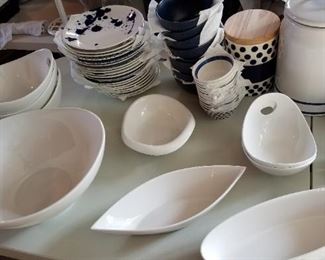 Various white serving bowls, Royal Doulton plates, navy cereal bowls, varying sized canisters