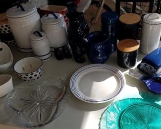 Varying sized canisters, navy blue serve ware, serving patters, butter dish, spoon rest