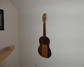 Old license plates made into guitar wall art