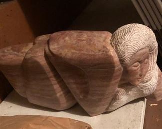 Stone sculpture of reclining woman 