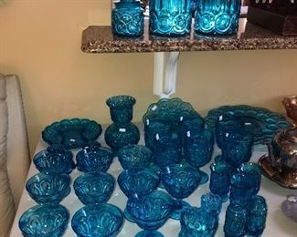 Tons of L & E Smith Moon & Stars pedestal water goblets, juice glasses, candy dishes, banana boat fruit dish, salt and pepper shakers , relish plate, set of three apothecary canisters, and candle holders.