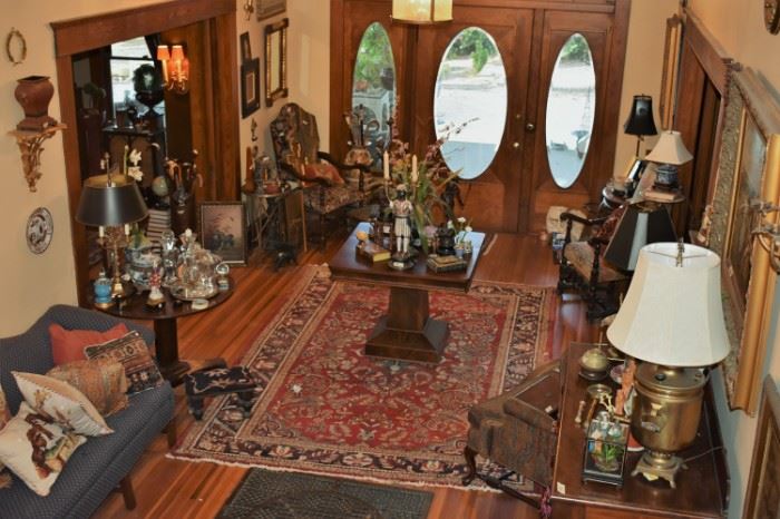 Needlepoint chairs, empire table, oil painting, oriental rug, needlepoint pillows, lamps, blackamoors, needlepoint footstool, walking canes
