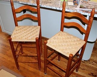 ONLINE AUCTION ITEM #20 - Three woven seat ladder back barstools -seat approximately 25” tall on 2 larger ones, 22.5” tall on smaller one.