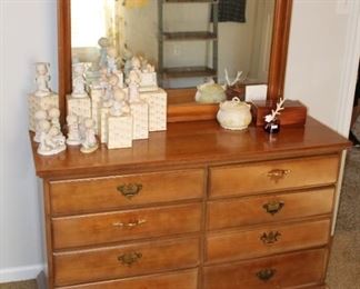 Dresser with mirror and Precious Moments figurines.  
