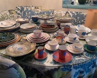 Various sets of dinnerwares waiting to be counted and priced.