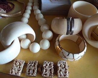 More ivory -two cuffs to left, bangle with silver catch are old, heavy. Beautiful. Beads and large bangles to right are not ivory but they look it. Carved bracelet is a mix of bone and ivory. Several sections are not seen.