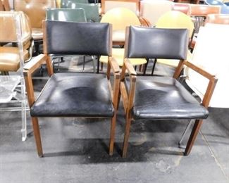 (2) Alma Desk black vinyl Teak wood arm chairs 