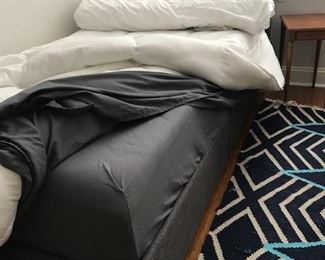 Twin bed with Casper style mattress and fabric headboard.