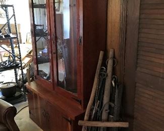 Gun cabinet and antique farm equipment 