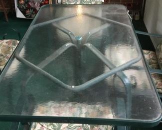 #29 Green Aluminum Glass Top Table w/4 chairs & cushions  60x37x28  $ 75.00
