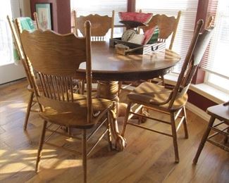 Oak table with six press back chairs