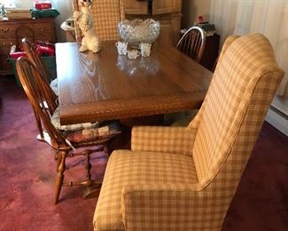 Oak Dining table with two leaves. Four Windsor style side chairs. Pair of wing back end chairs