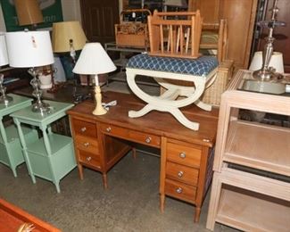wooden desk, end tables, desk lamps, glass end tables, ottoman. 