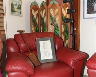 red leather chair, decorative metal conoe paddle, hand painted Mexican screen
