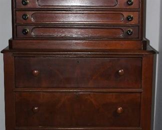 Antique 6 Drawer Spool Cabinet (29” W x 19” D x 21 1/2” H) attached to an Antique 3 Drawer lowboy Chest with bracket feet and scalloped apron.  (32” W x 20” D x 31” H). This was used as their silver storage cabinet.