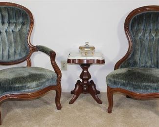 Victorian Carved Wood Frame Lady’s and Gentleman’s Chairs Blue rolled and tufted velvet upholstery shown with White marble top small Pedestal Victorian Style Side table/plant stand, 14” W x 14” D x 19” H and gold encrusted glass 3 toed Candy Dish