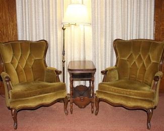 Vintage Wood Frame Tufted Winged Chairs shown with Depression Era Occasional Table with book trough and brass adjustable arm floor lamp