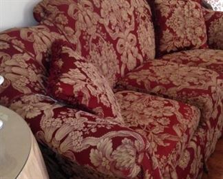 An additional red and gold 3-cushion sofa