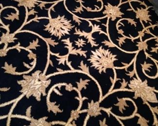 Black and gold round rug 5 feet 8 inches