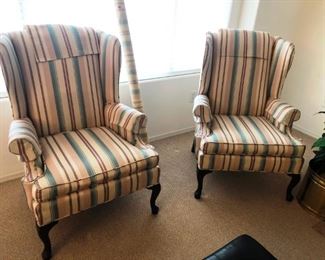 Matching pair of wing back chairs with extra fabric