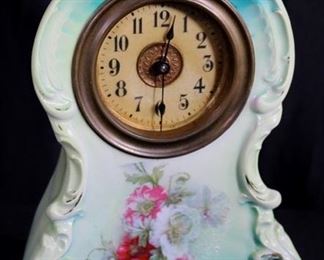 310b  Porcelain clock with wind up works, 11 in. T.