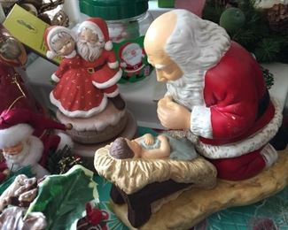 Santa bowing to Jesus ceramic figurine