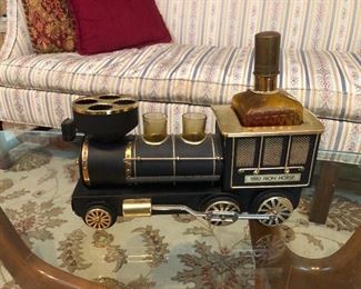 Is that a vintage Avon cologne bottle in the shape of a steam engine? No, turns out it's a metal-car music box/whiskey decanter with shot glasses that plays "How Dry I Am." What home is complete without this?