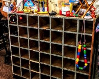 LARGE WOODEN CUBBIE WITH OLD TOYS ON TOP