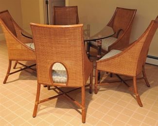 5 Barbara Barry for McGuire caned arm chairs in pecan finish; custom upholstery; McGuire bamboo and rawhide 5-leg table with beveled glass top