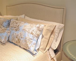 Crate & Barrel Queen bed with nail head trim upholstered headboard. Side rails and footboard are also upholstered. Bedding not for sale