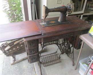 Antique Singer sewing table (the leaf on the left can be lifted up and folded back down to cover the sewing machine, which lowers down for easy storage).